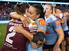 Julia Robinson of the Maroons and Yasmin Meakes of the Blues embrace following game one of the Women's State of Origin series.
