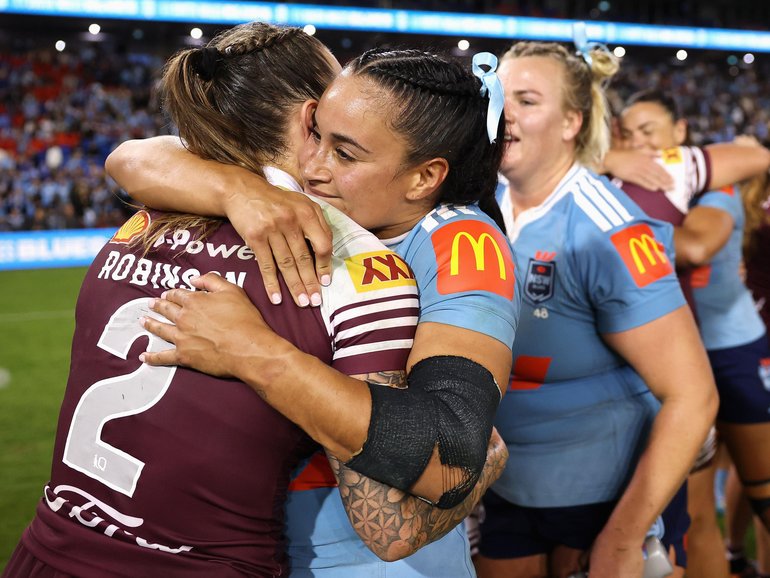 Julia Robinson of the Maroons and Yasmin Meakes of the Blues embrace following game one of the Women's State of Origin series.