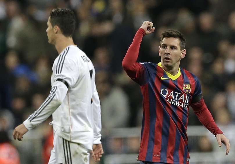 In this 2014 file photo FC Barcelona's Lionel Messi, right celebrates next to Real Madrid's Cristiano Ronaldo after scoring his team's second goal during a Spanish La Liga soccer match.