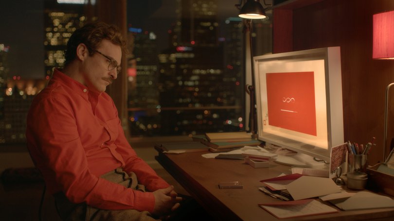 Joaquin Phoenix plays Theodore Twombly, who falls in love with the first artificially intelligent operating system, in the film Her.