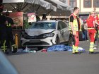 Rescue workers stand next to a damaged car that crashed into several people in Leipzig. 