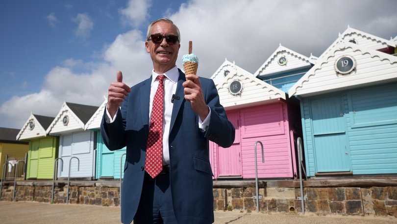Reform UK leader Nigel Farage enjoys an ice cream after casting his vote during the local council elections.