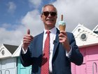 Reform UK leader Nigel Farage enjoys an ice cream after casting his vote during the local council elections.
