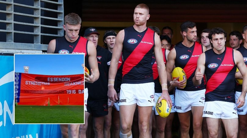 Essendon walk out as the Giants unveil a cheeky banner. 