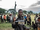 A Wazalendo militant surrenders a weapon to members of the Rwanda-backed M23 rebel group on December 15, 2025.