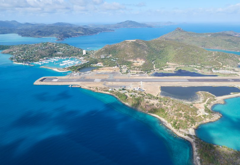 Aerial view of Hamilton Island and the airstrip at the east coast and the pacific ocean.