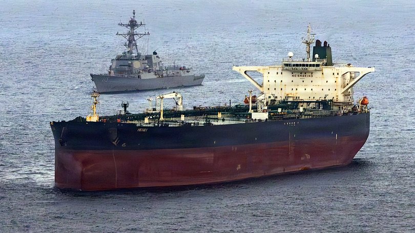 This US Navy handout photo released on May 8, 2026 by US Central Command Public Affairs, shows the Arleigh Burke-class guided-missile destroyer USS Rafael Peralta (DDG 115) implementing a maritime blockade against the Iran-flagged crude oil tanker vessel Herby while the latter was attempting to sail toward an Iranian port, on April 24, 2026. The war launched by the US and Israel in late February saw Iran respond with attacks across the Middle East and maintain a stranglehold on the Strait of Hormuz, choking off major flows of oil, gas, and fertilizer to the world economy, while the US has imposed a counter-blockade on Iranian ports. (Photo by US NAVY / AFP) / RESTRICTED TO EDITORIAL USE - MANDATORY CREDIT "AFP PHOTO / US NAVY / NAVCENT PUBLIC AFFAIRS" - HANDOUT - NO MARKETING NO ADVERTISING CAMPAIGNS - DISTRIBUTED AS A SERVICE TO CLIENTS