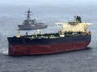 This US Navy handout photo released on May 8, 2026 by US Central Command Public Affairs, shows the Arleigh Burke-class guided-missile destroyer USS Rafael Peralta (DDG 115) implementing a maritime blockade against the Iran-flagged crude oil tanker vessel Herby while the latter was attempting to sail toward an Iranian port, on April 24, 2026. The war launched by the US and Israel in late February saw Iran respond with attacks across the Middle East and maintain a stranglehold on the Strait of Hormuz, choking off major flows of oil, gas, and fertilizer to the world economy, while the US has imposed a counter-blockade on Iranian ports. (Photo by US NAVY / AFP) / RESTRICTED TO EDITORIAL USE - MANDATORY CREDIT "AFP PHOTO / US NAVY / NAVCENT PUBLIC AFFAIRS" - HANDOUT - NO MARKETING NO ADVERTISING CAMPAIGNS - DISTRIBUTED AS A SERVICE TO CLIENTS