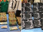 Three people were arrested at two properties after large sums of drugs, cash were found.