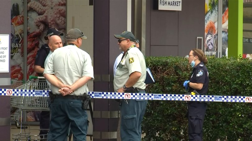 Police, investigators and Armaguard security guards at Eli Waters Shopping Centre following the alleged heist.