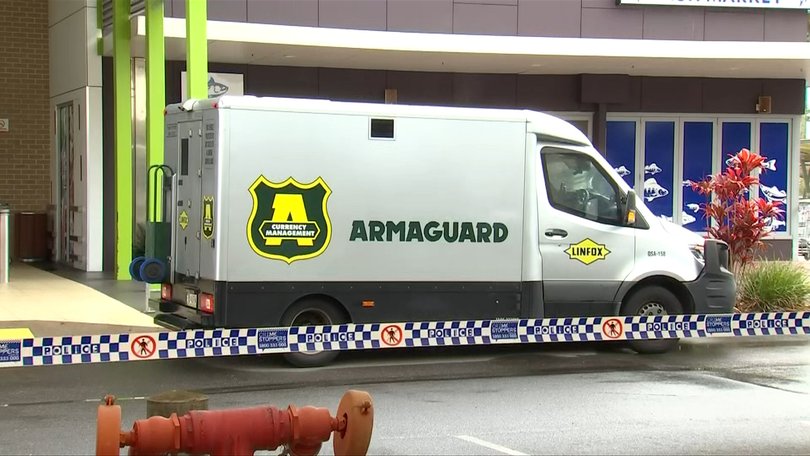 An Armaguard cash-in-transit vehicle at Eli Waters Shopping Centre following the alleged armed robbery on Tuesday morning.