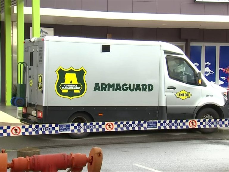 An Armaguard cash-in-transit vehicle at Eli Waters Shopping Centre following the alleged armed robbery on Tuesday morning.
