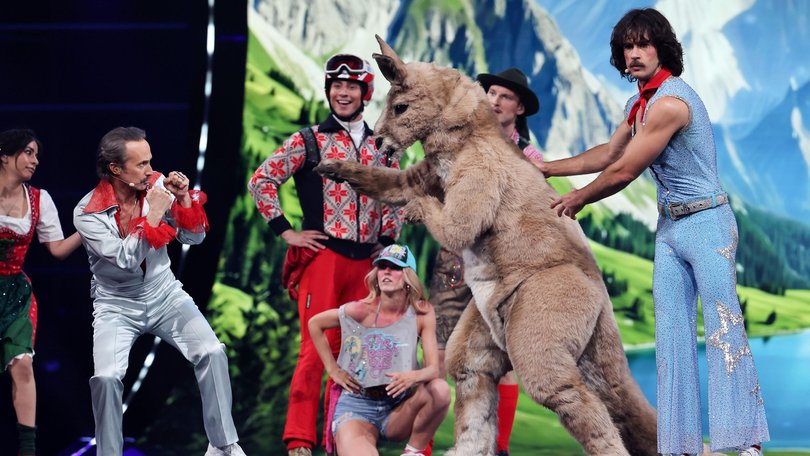 Go-Jo (r) and presenter Michael Ostrowski (l) at the first semi-final of the 70th Eurovision Song Contest on the stage of the Stadthalle in Vienna.