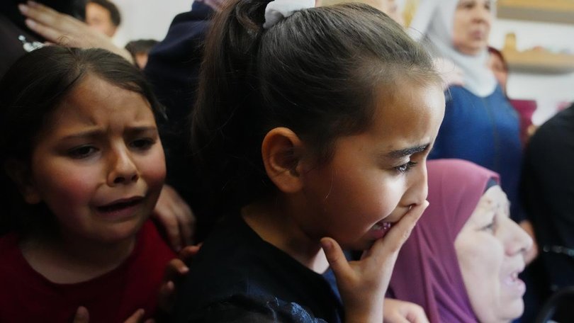 Children cry at the funeral for the Palestinian man shot  trying to climb the wall to find work. (AP PHOTO)