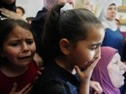Children cry at the funeral for the Palestinian man shot  trying to climb the wall to find work.