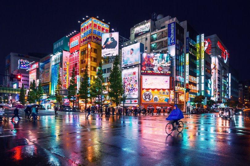 Neon lights and billboard advertisements on buildings in Tokyo, Japan.
