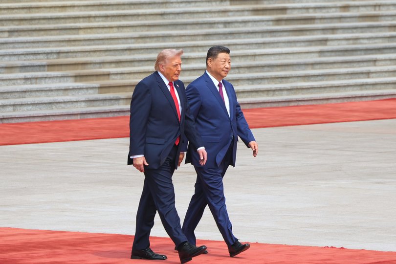 President Donald Trump walks with Chinese President Xi Jinping.