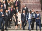 Members of the U.S> delegation, including Apple CEO Tim Cook, center, arrive before President Donald Trump is greeted by Chinese President Xi Jinping at a welcome ceremony at the Great Hall of the People, Thursday, May 14, 2026, in Beijing. (AP Photo/Mark Schiefelbein)