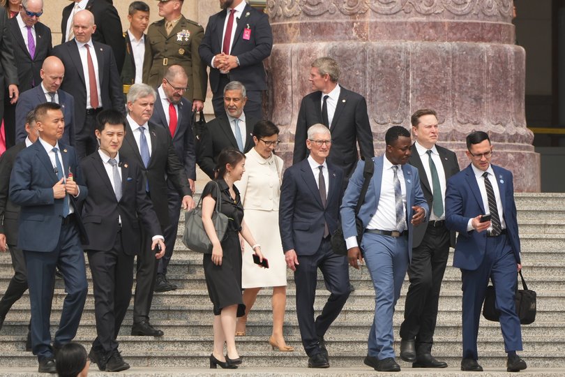 Members of the US delegation, including Apple CEO Tim Cook, centre, and SpaceX’s Elon Musk. 