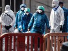 Passengers carry their belongings in plastic bags after being evacuated from the MV Hondius after docking in the Granadilla Port  in Tenerife.