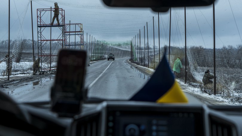 Soldiers install anti-drone netting over a road between Izium and Sloviansk, in the Donetsk region of Ukraine, March 6, 2026.