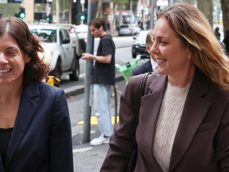 Cate Sayers (right) walks out of court with her lawyer Sue Chrysanthou. NewsWire / David Caird