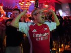 Arsenal supporters celebrate the club's first title in 22 years near the club's stadium. 