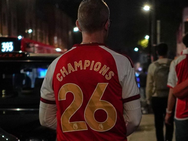 Arsenal supporters have hit the North London streets to celebrate the club's latest title win. (AP PHOTO)