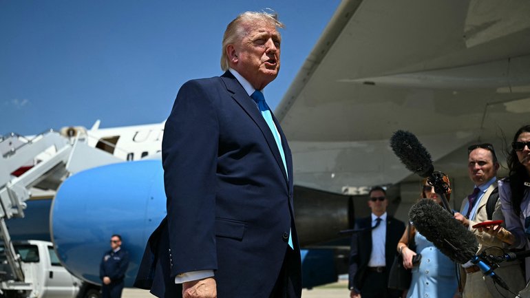 President Donald Trump speaks to reporters after stepping off Air Force One.