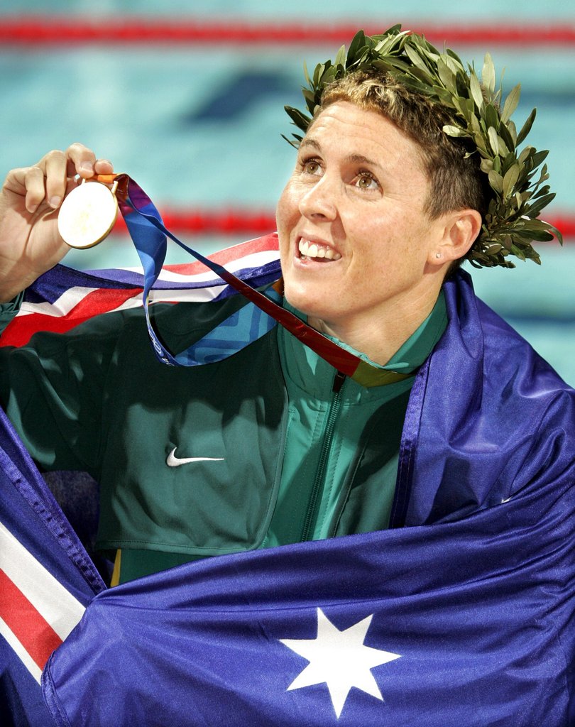 Australia's Petria Thomas celebrates with her gold medal after winning the 100-meter butterfly at the Olympic Aquatic Centre during the 2004 Olympic Games in Athens, Sunday Aug. 15, 2004.