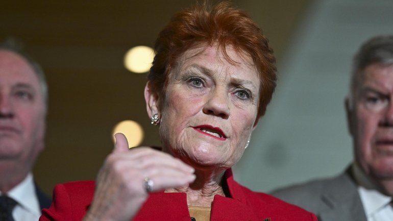 Pauline Hanson has been caught on a hot mic making a rude remark about a journalist following a tense exchange at a press conference.