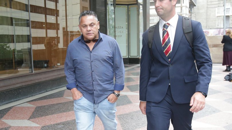 Trindall (L) and his lawyer James Drewett (R) left the Downing Centre Local Court on Friday after the ex-NRL star was sentenced to a 12-month community order. NewsWire / Christian Gilles