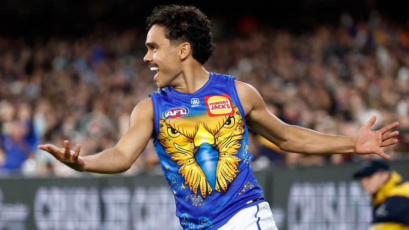 Malakai Champion kicks a goal.