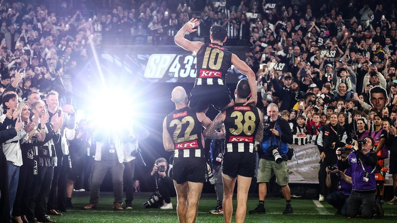 Scott Pendlebury of the Magpies chaired off by Steele Sidebottom and Jeremy Howe.
