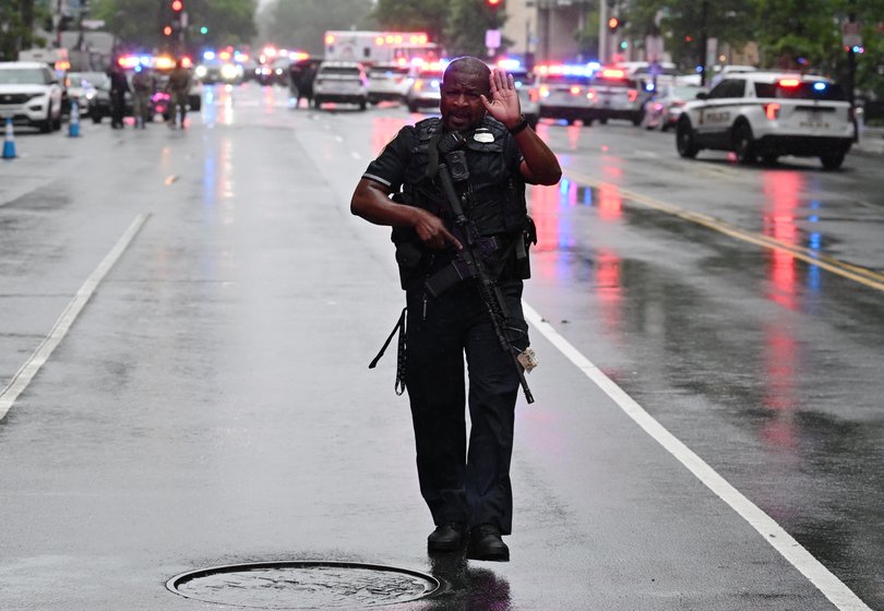 Members of the U.S. Secret Service clear pedestrians from the scene.