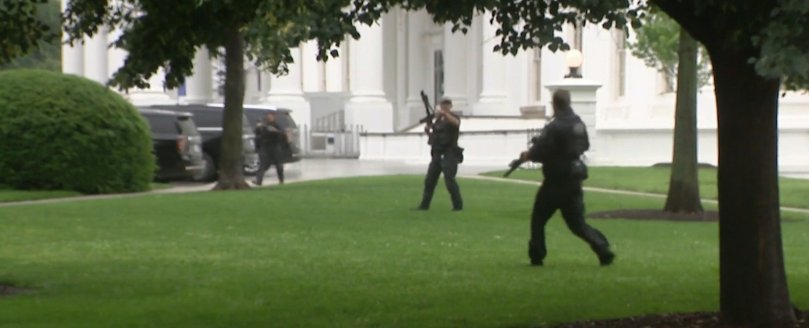 Law enforcement officers scour the White House grounds during the shooting.