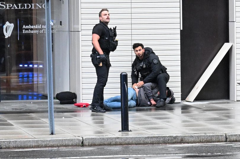 Members of the U.S. Secret Service tend to a wounded man on the scene of a shooting near the White House on May 23, 2026.