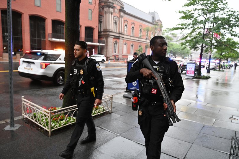 Members of the U.S. Secret Service clear pedestrians from the scene.