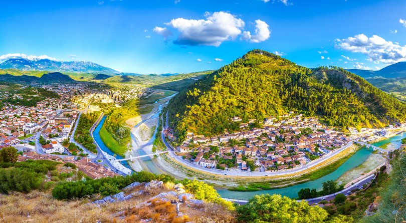 Above, old houses of Berat, historic city in Albania; historical Ottoman Houses in neighborhoods Gorica and Mangalem in Berat, with bridges over river Osum, Albania 