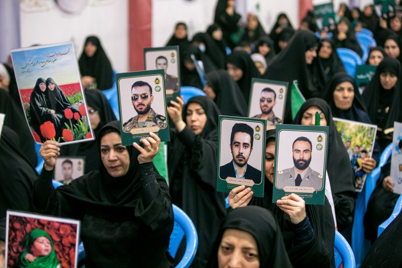 People hold portraits of the dead at the Imam Khomeini Mosalla Mosque to commemorate those killed in the current US-Israeli war as well as previous wars on May 24, 2026 in Tehran, Iran.