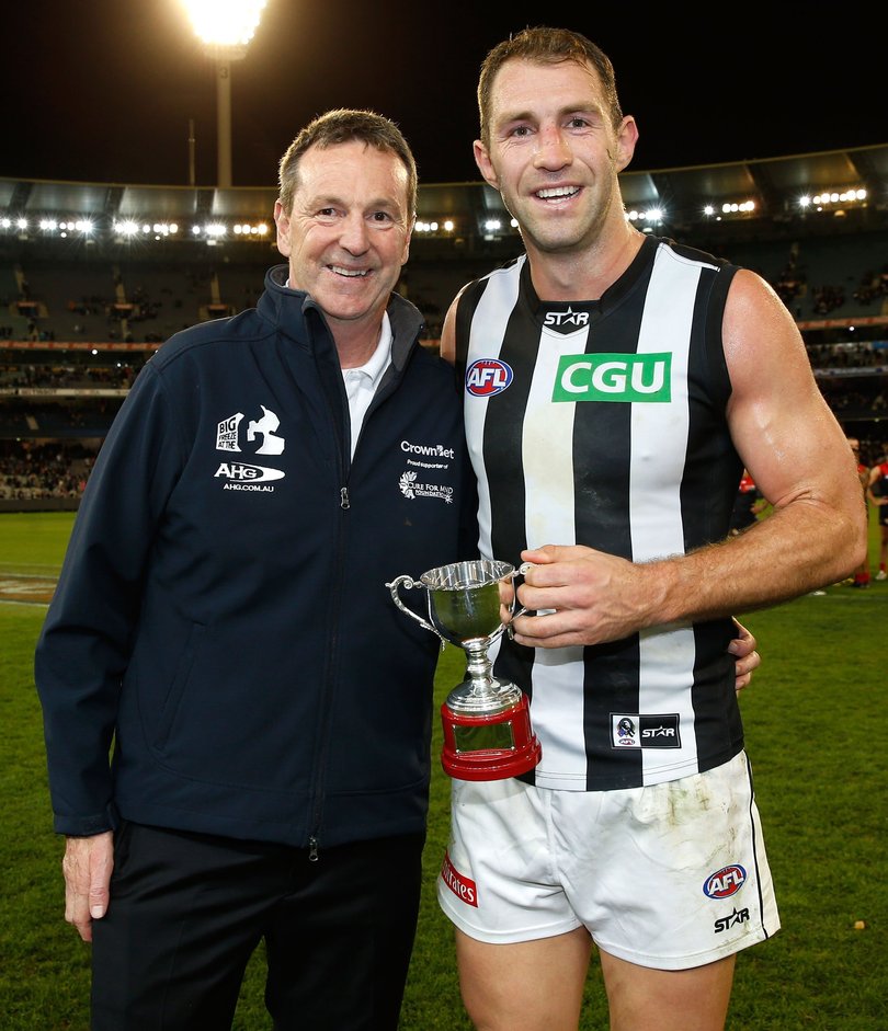 Neale Daniher presents Travis Cloke with the inaugural Neale Daniher Trophy.