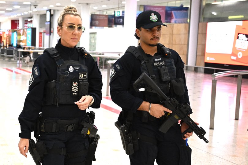 Australian Federal Police officers patrol Sydney International Airport.