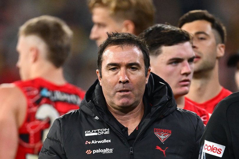 Brad Scott, Senior Coach of the Bombers, looks on after talking to his players.