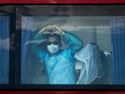 TENERIFE, SPAIN - MAY 11: A passenger from the final group to be evacuated from the MV Hondius makes a heart from a bus on the way to the airport in the Granadilla Port on May 11, 2026 in Tenerife, part of the Canary Islands, Spain. The cruise ship MV Hondius, which had three passengers die from Hantavirus last month and eight more reported cases, docked in Tenerife on May 10th, where the remaining passengers are being repatriated to their respective countries. At a press conference this week, representatives of the World Health Organization (WHO) emphasized the outbreak of this rare virus did not constitute a pandemic, but it has stirred anxieties in the Canary Islands and elsewhere. (Photo by Chris McGrath/Getty Images)
