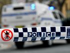 A man has been charged after allegedly threatening staff at a medical facility while carrying firearms.