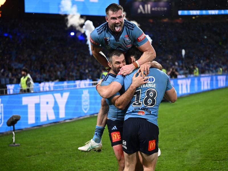 NSW have come from behind to beat Queensland with Ethan Strange (top) starring on debut. 