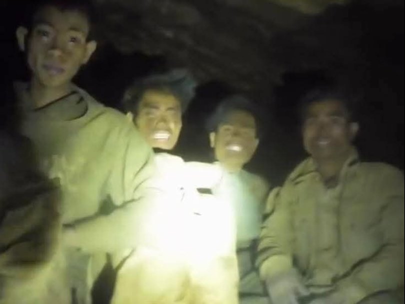 Rescuers found five smiling men in the flooded cave.