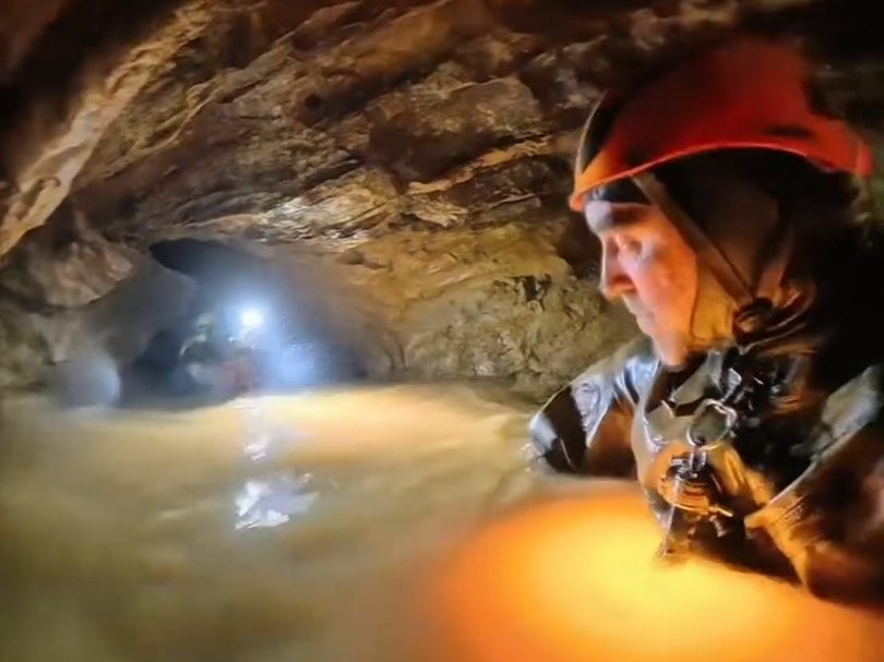 Five people have been rescued from a flooded cave in Laos, the search continues for two others.