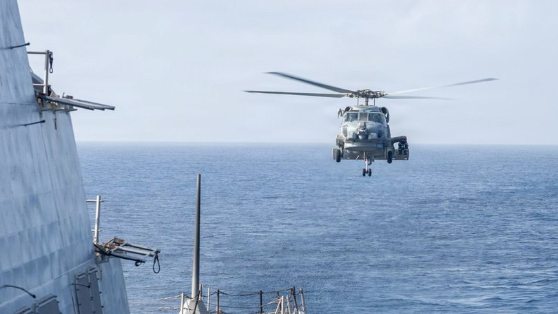 An MH-60R Sea Hawk helicopter approaches USS Delbert D. Black after patrolling the Arabian Sea in support of the US blockade of Hormuaz.