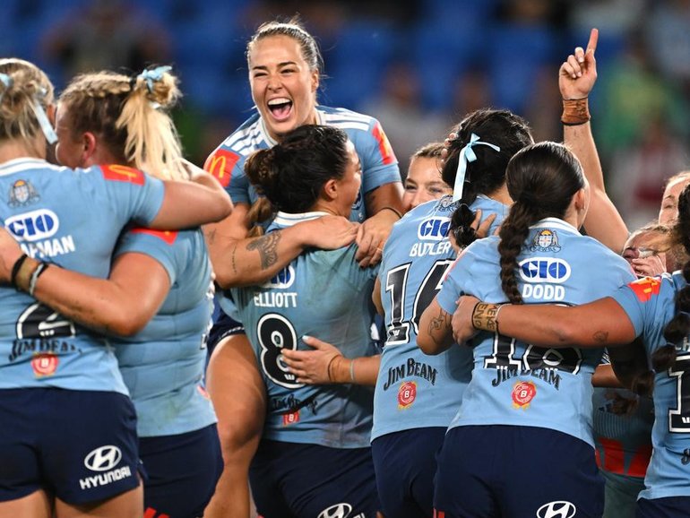 History: NSW players celebrate a first clean sweep in the women's State of Origin series. (Dave Hunt/AAP PHOTOS)